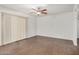 Bright living room with wood-look floors, vertical blinds, and a ceiling fan at 10610 S 48 St # 1068, Phoenix, AZ 85044