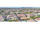 Aerial view of homes showcasing the community, with lush landscaping, a pool, and desert mountain views at 10643 E Tumbleweed Ave, Mesa, AZ 85212