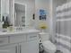 Simple bathroom with single sink vanity and neutral shower curtain at 10643 E Tumbleweed Ave, Mesa, AZ 85212