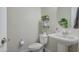 Neat bathroom with toilet, sink, mirror, and stylish shelves at 10643 E Tumbleweed Ave, Mesa, AZ 85212