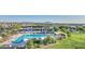 Community pool and splashpad set among shade structures, lush landscaping, and mountain views at 10643 E Tumbleweed Ave, Mesa, AZ 85212
