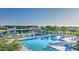 Large community pool with chairs, umbrellas, and a clubhouse surrounded by manicured landscaping at 10643 E Tumbleweed Ave, Mesa, AZ 85212