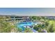 Expansive community pool area featuring ample seating, umbrellas, and beautiful desert landscaping at 10643 E Tumbleweed Ave, Mesa, AZ 85212