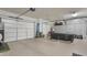 Spacious three car garage with epoxy floors and custom storage cabinets at 10643 E Tumbleweed Ave, Mesa, AZ 85212