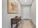 Inviting hallway featuring a console table, elegant artwork, and stylish wood-look tile flooring at 10643 E Tumbleweed Ave, Mesa, AZ 85212