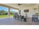 Inviting covered patio with comfortable seating and a view of the manicured backyard at 10643 E Tumbleweed Ave, Mesa, AZ 85212