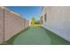 Backyard putting green with manicured lawn and a view of the community landscaping at 10643 E Tumbleweed Ave, Mesa, AZ 85212