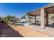 Backyard featuring covered patio, swimming pool and storage shed at 12132 W Caribbean Ln, El Mirage, AZ 85335