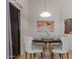 This dining area features a round table, four chairs, and modern decor for an inviting meal space at 12132 W Caribbean Ln, El Mirage, AZ 85335