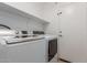 Laundry room featuring washer, dryer, white walls and shelf at 12132 W Caribbean Ln, El Mirage, AZ 85335