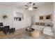 Light and airy living room with neutral colors, a ceiling fan, and comfortable seating at 12132 W Caribbean Ln, El Mirage, AZ 85335