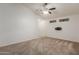 Carpeted living room with ceiling fan and minimal decor, ready for personalization at 12132 W Caribbean Ln, El Mirage, AZ 85335