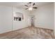 Living room with carpet, ceiling fan, and ample natural light at 12132 W Caribbean Ln, El Mirage, AZ 85335