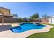Backyard pool with steps, waterfall feature, and putting green at 12132 W Caribbean Ln, El Mirage, AZ 85335