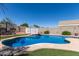 Backyard pool and jacuzzi with putting green, block fence, and shed at 12132 W Caribbean Ln, El Mirage, AZ 85335