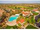 Aerial view of community pool and amenities surrounded by lush landscaping and well-maintained buildings at 13716 W Nogales Dr, Sun City West, AZ 85375