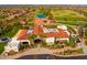 Stunning aerial view of the community clubhouse showcasing the tile roof, landscaping, and circular driveway at 13716 W Nogales Dr, Sun City West, AZ 85375