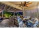 Outdoor living space with comfortable seating, dining area, fire pit, and built-in grill at 13716 W Nogales Dr, Sun City West, AZ 85375