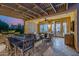 Covered patio with a dining area, outdoor seating, and an outdoor grill station at 13716 W Nogales Dr, Sun City West, AZ 85375