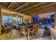 Cozy back patio featuring an outdoor kitchen, dining area, and living space with a pool at 13716 W Nogales Dr, Sun City West, AZ 85375