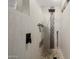 Shower in bathroom with modern fixtures, unique tile designs, and built in niche at 13716 W Nogales Dr, Sun City West, AZ 85375