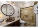 This bathroom has an attractive granite counter, a copper sink, and a tiled walk-in shower at 13716 W Nogales Dr, Sun City West, AZ 85375