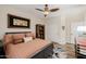 This cozy bedroom features wood floors, an area rug, and a ceiling fan at 13716 W Nogales Dr, Sun City West, AZ 85375