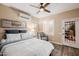 Inviting bedroom features wood floors, a ceiling fan, and a comfortable seating area at 13716 W Nogales Dr, Sun City West, AZ 85375