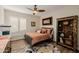 Comfortable bedroom features wood floors, a ceiling fan, and a decorative area rug at 13716 W Nogales Dr, Sun City West, AZ 85375