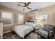 This lovely bedroom features wood floors, a ceiling fan, and bright natural light at 13716 W Nogales Dr, Sun City West, AZ 85375
