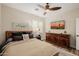 Bedroom with neutral walls, ceiling fan, wood flooring and modern furnishings at 13716 W Nogales Dr, Sun City West, AZ 85375