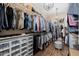 Walk-in closet features wood floors, plenty of storage, and shelving with racks at 13716 W Nogales Dr, Sun City West, AZ 85375