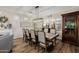 Beautiful dining area featuring a long wooden table, comfortable chairs, and elegant decor at 13716 W Nogales Dr, Sun City West, AZ 85375