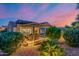 Back of the house with an outdoor patio with exterior lighting and landscaping at 13716 W Nogales Dr, Sun City West, AZ 85375