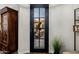 Elegant entryway with a glass-paneled door and view of patio with comfortable seating and a fire pit at 13716 W Nogales Dr, Sun City West, AZ 85375