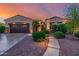 Charming home exterior with desert landscaping and a tile roof in a warm sunset glow at 13716 W Nogales Dr, Sun City West, AZ 85375