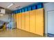 Garage with built-in storage cabinets and blue storage containers against a white door at 13716 W Nogales Dr, Sun City West, AZ 85375