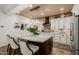 Beautiful kitchen with a granite island, pendant lighting, and modern appliances at 13716 W Nogales Dr, Sun City West, AZ 85375