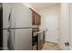 Convenient laundry area with modern washer and dryer and ample cabinet space at 13716 W Nogales Dr, Sun City West, AZ 85375