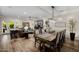 Spacious open-concept living and dining area with hardwood floors and stylish furnishings at 13716 W Nogales Dr, Sun City West, AZ 85375