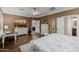 Comfortable main bedroom with dresser, television, walk in closet, and entry to the bathroom at 13716 W Nogales Dr, Sun City West, AZ 85375