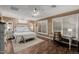 Spacious main bedroom features wood flooring, natural light, and a ceiling fan at 13716 W Nogales Dr, Sun City West, AZ 85375