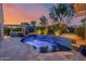 Outdoor pool with a built in water feature, an umbrella, and manicured landscaping at 13716 W Nogales Dr, Sun City West, AZ 85375