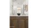 Close up on bathroom featuring double vanity, decorative bowl, and framed art for a contemporary design at 15348 W Gray Fox Trl, Surprise, AZ 85387