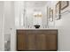 Bathroom featuring double vanity, decorative bowl, and framed art for a contemporary design at 15348 W Gray Fox Trl, Surprise, AZ 85387