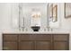 Bathroom featuring double vanity, decorative bowl, and framed art for a contemporary design at 15348 W Gray Fox Trl, Surprise, AZ 85387
