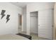 Modern bedroom featuring neutral decor, stylish closet, and lightning bolt wall art at 15348 W Gray Fox Trl, Surprise, AZ 85387