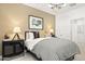 Tastefully decorated bedroom with patterned bedding, modern lighting, and chic accents at 15348 W Gray Fox Trl, Surprise, AZ 85387