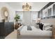 Comfortable bedroom featuring a dresser, a large accent mirror, and a neutral color palette at 15348 W Gray Fox Trl, Surprise, AZ 85387
