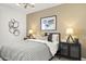 Tastefully decorated bedroom with patterned bedding, modern lighting, and chic accents at 15348 W Gray Fox Trl, Surprise, AZ 85387
